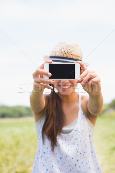 Pretty brunette taking a selfie in park Stock photo © wavebreak_media