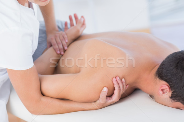 Physiotherapist doing shoulder massage to her patient Stock photo © wavebreak_media
