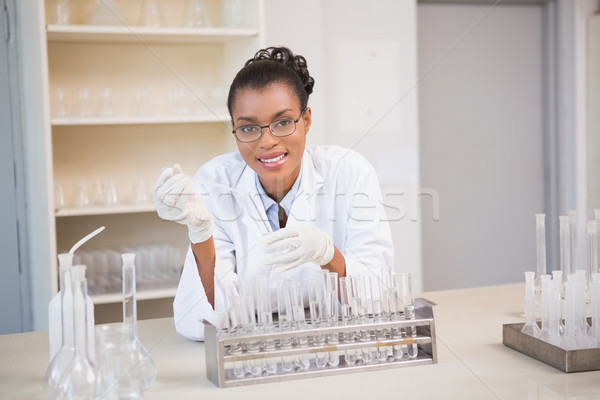 Smiling scientist working with pipette Stock photo © wavebreak_media