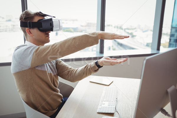 Happy executive using virtual reality headset Stock photo © wavebreak_media