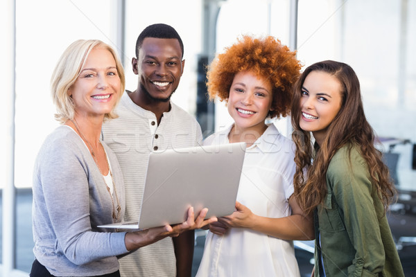 Portrait of happy colleagues with laptop Stock photo © wavebreak_media