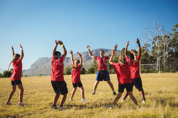Stock photo: Trainer training kids in the boot camp