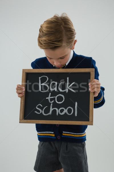 Iskolás fiú tart szöveg fehér imádnivaló férfi Stock fotó © wavebreak_media