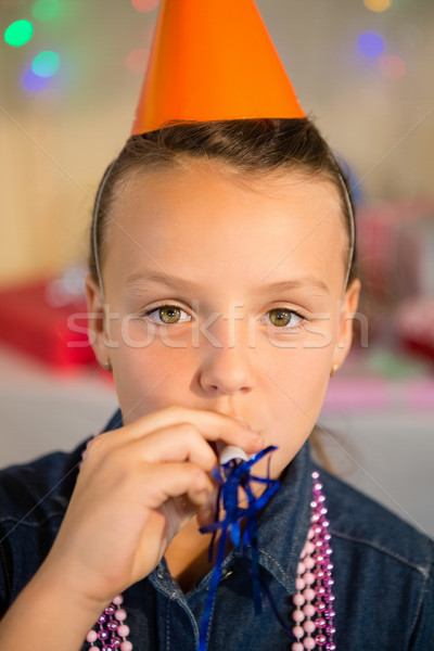 Girl blowing party horn during birthday party Stock photo © wavebreak_media