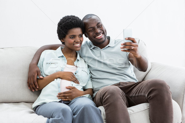 Pregnant couple taking a selfie on mobile phone Stock photo © wavebreak_media