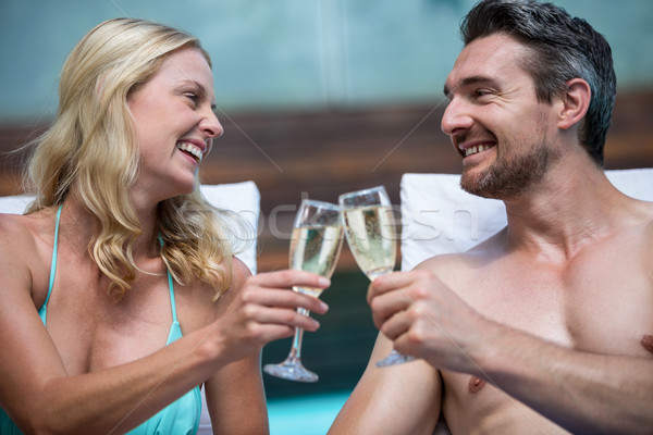 Couple séance soleil champagne piscine [[stock_photo]] © wavebreak_media