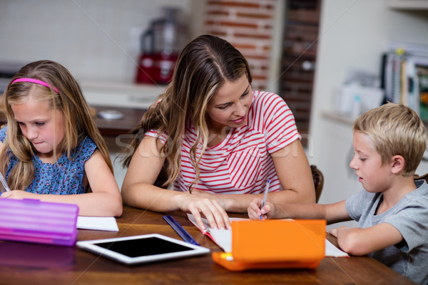 Mother helping kids with their homework Stock photo © wavebreak_media