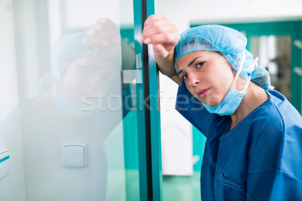 Portrait of sad surgeon leaning against the glass door Stock photo © wavebreak_media