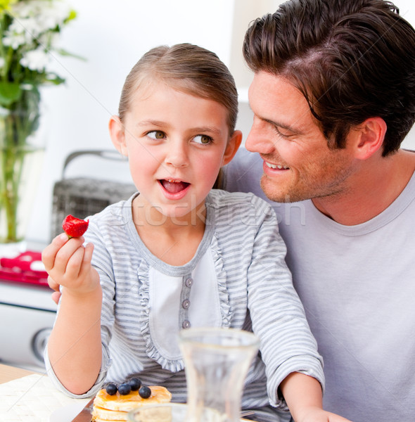 Smiling father and his daughter having breakfast together Stock photo © wavebreak_media
