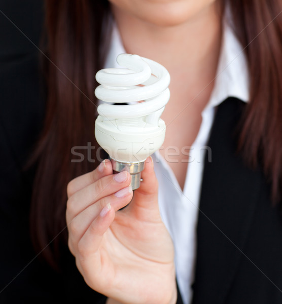 Close-up of a young businesswoman holding a light bulb in her office Stock photo © wavebreak_media