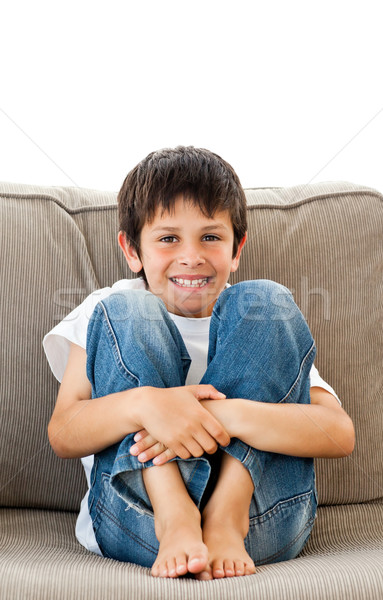 Portrait of an adorable boy sitting on the sofa at home Stock photo © wavebreak_media