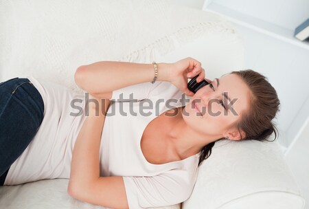 Stock photo: Sleeping beautiful woman lying on a bed in her bedroom