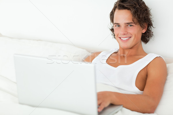 [[stock_photo]]: Souriant · homme · portable · chambre · ordinateur · internet