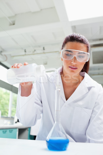 Portrait of a female science student pouring liquid in a laboratory Stock photo © wavebreak_media