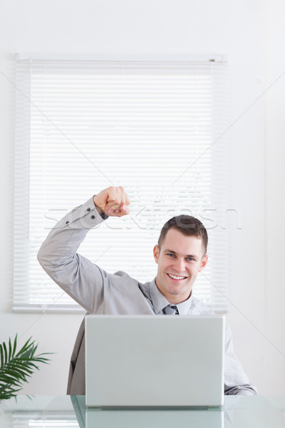 Stock photo: Young businessman getting awesome news via email