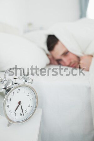 Woman being awakened by her alarm clock in her bedroom Stock photo © wavebreak_media