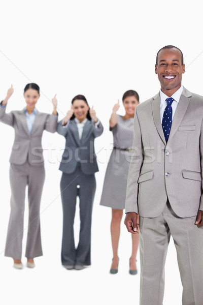 Happy businessman with three approving co-workers in background with thumbs up Stock photo © wavebreak_media