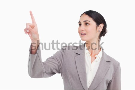 Young businesswoman with a smile giving thumbs up against a white background Stock photo © wavebreak_media