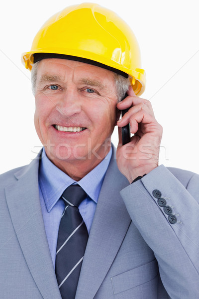 Close up of smiling mature architect on his cellphone against a white background Stock photo © wavebreak_media