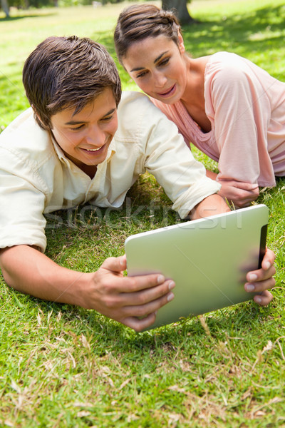 Dois amigos sorridente ver algo comprimido Foto stock © wavebreak_media