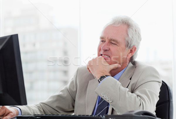 Happy senior manager working with a monitor in his office Stock photo © wavebreak_media