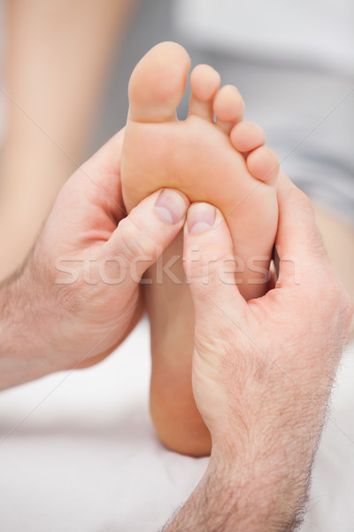 Hands massaging a foot on a medical table Stock photo © wavebreak_media