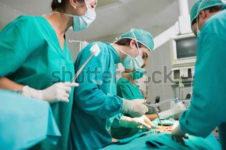 Nurse adjusting a monitor in an operating theatre Stock photo © wavebreak_media