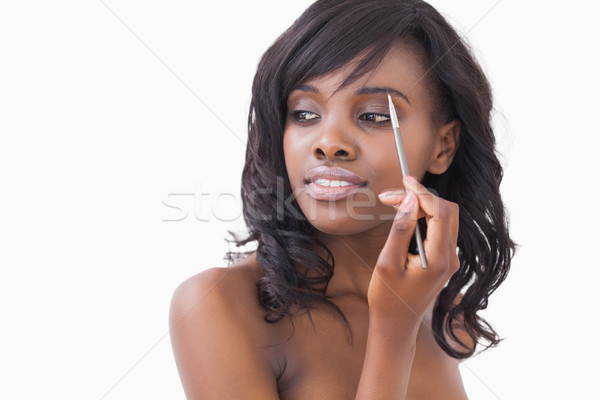 Smiling woman holding eye shadow brush to eyes Stock photo © wavebreak_media
