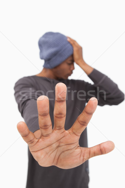 Man in beanie hat holding hand out to stop Stock photo © wavebreak_media