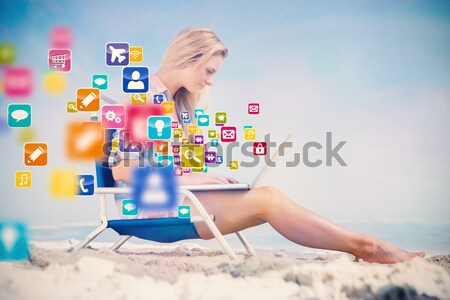 Composite image of gorgeous blonde in bikini using laptop on the Stock photo © wavebreak_media