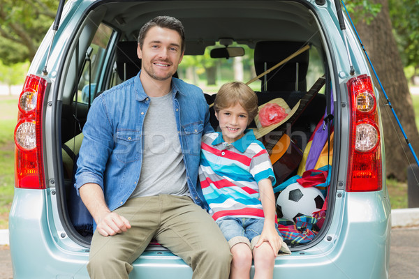 Happy father and son sitting in car trunk Stock photo © wavebreak_media