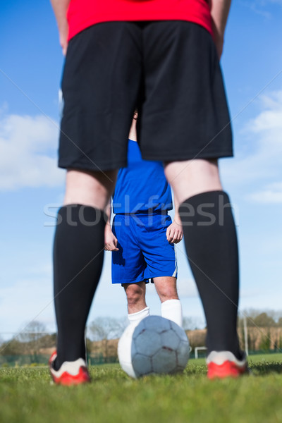 Stock photo: Football players facing off on pitch