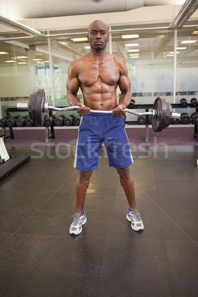 Izmos férfi emel súlyzó tornaterem portré Stock fotó © wavebreak_media