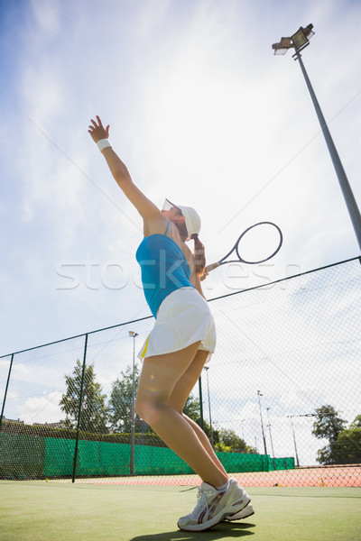 Stock photo: Pretty tennis player about to serve