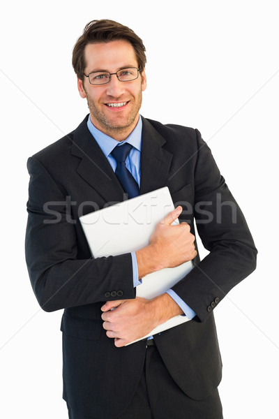 Smiling businessman holding his laptop looking at camera Stock photo © wavebreak_media