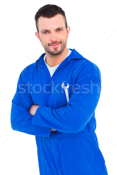 Happy mechanic holding spanner on white background Stock photo © wavebreak_media