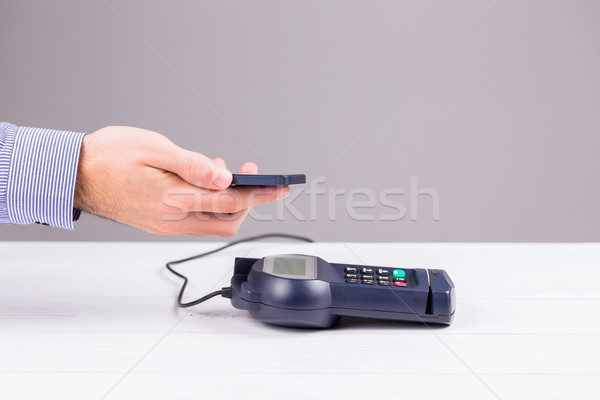 Stock photo: Man using smartphone to express pay 