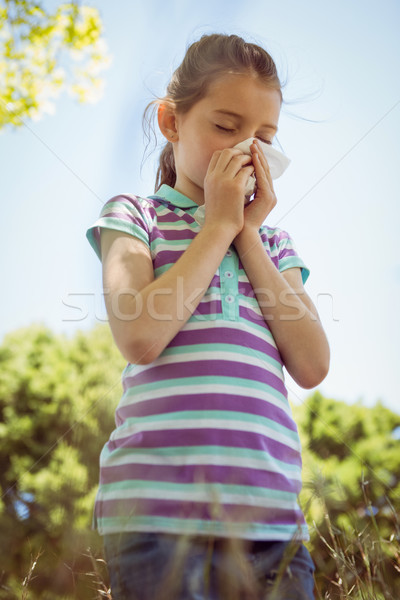 Cute little girl blowing her nose in park Stock photo © wavebreak_media