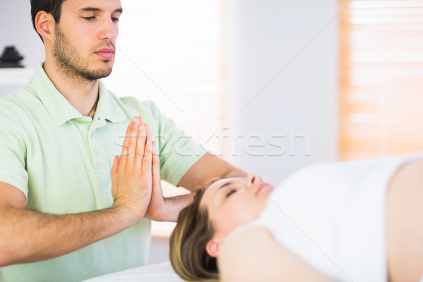 Relaxed pregnant woman getting reiki treatment Stock photo © wavebreak_media