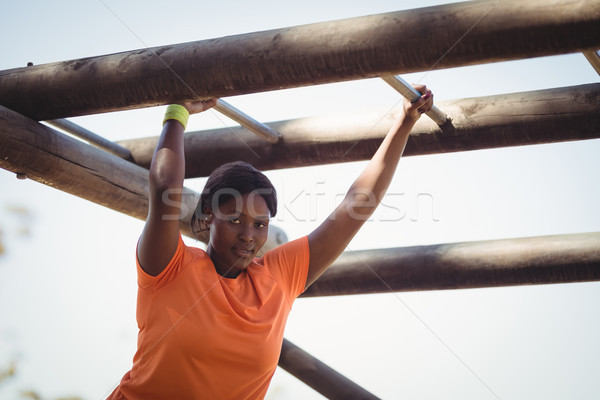 Portrait of woman exercising on monkey bar during obstacle course Stock photo © wavebreak_media