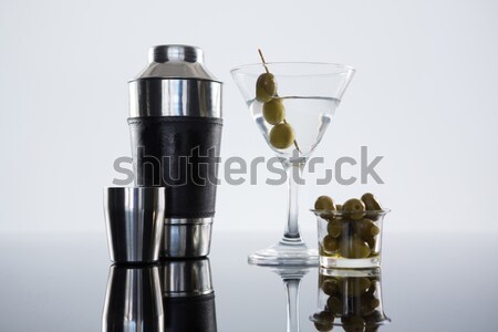 Cocktail martini with olives and shaker on table Stock photo © wavebreak_media