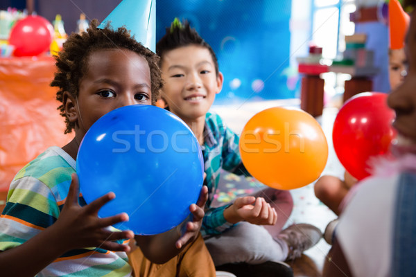 Portrait of children playing with colorful balloon Stock photo © wavebreak_media