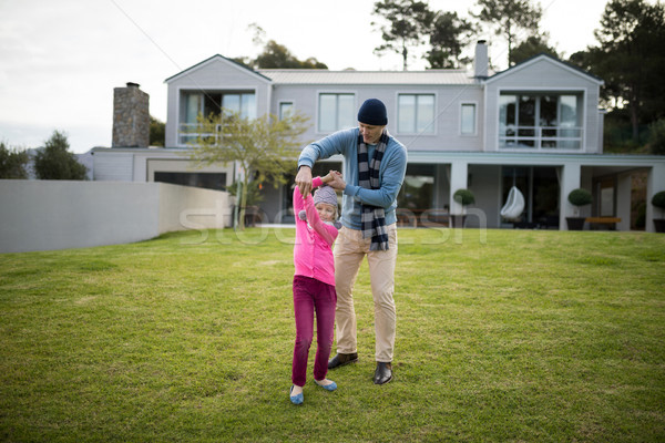 Stock photo: Father and daughter dancing in garden