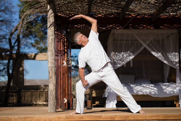 Man practicing yoga in cottage Stock photo © wavebreak_media