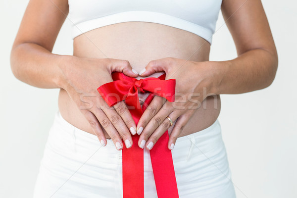 Terhes nő vörös szalag körül dudorodás fehér piros Stock fotó © wavebreak_media
