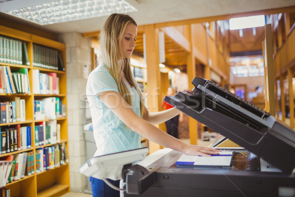 Smiling blonde student making a copy Stock photo © wavebreak_media