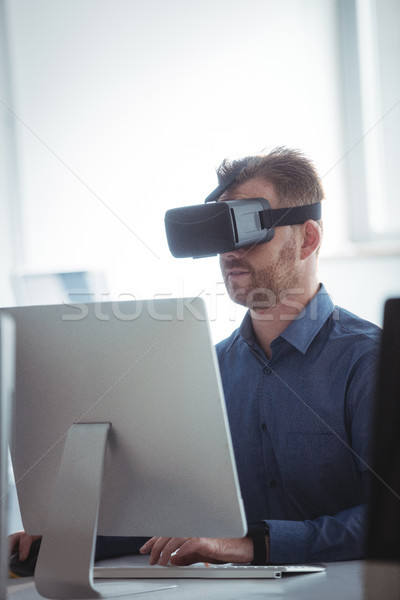 Stock photo: Mature student in virtual reality headset using computer