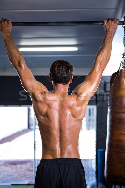 Rear view of shirtless athlete doing chin-ups  Stock photo © wavebreak_media