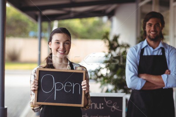 Waiter and waitress standing with chalkboard with open sign  Stock photo © wavebreak_media