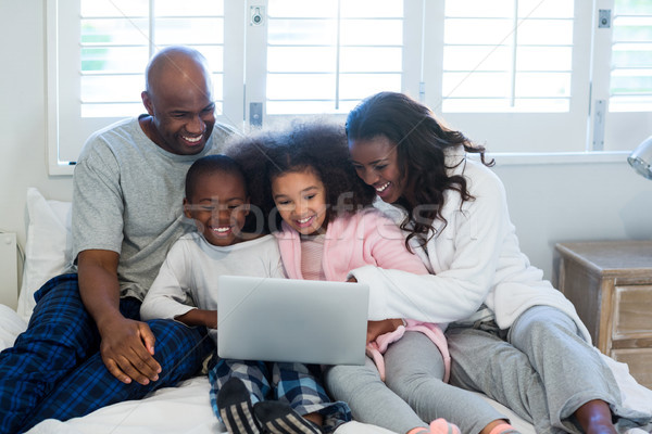Family using laptop on bed Stock photo © wavebreak_media
